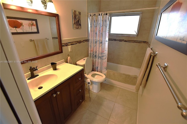 full bathroom featuring tile patterned flooring, shower / bath combination with curtain, toilet, vanity, and tile walls