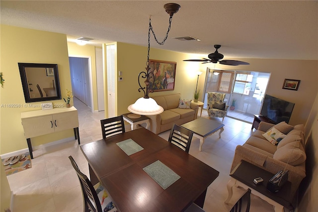 dining room with ceiling fan and a textured ceiling