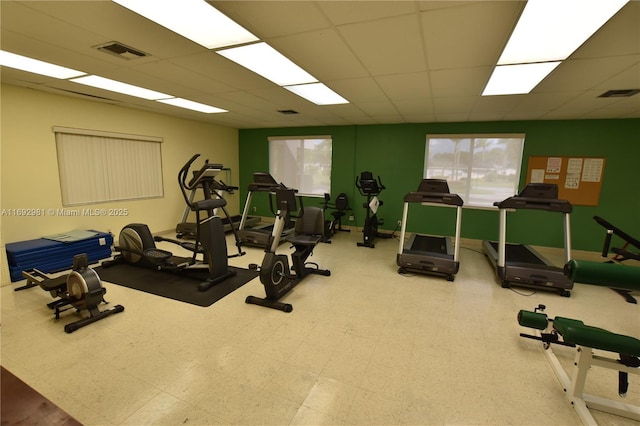 exercise room featuring a paneled ceiling