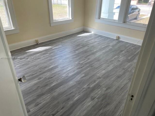 spare room with dark wood-type flooring