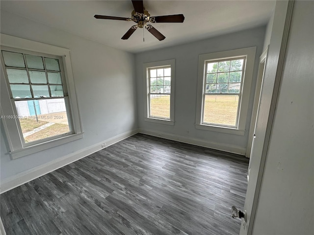 empty room featuring dark hardwood / wood-style flooring and ceiling fan