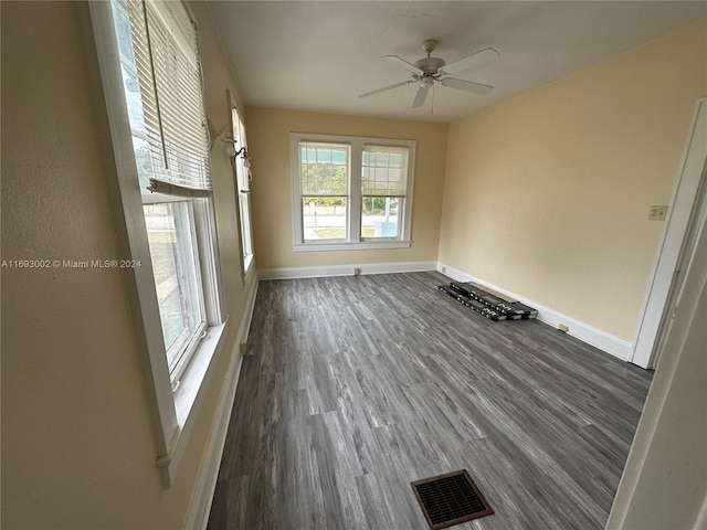 spare room featuring ceiling fan and dark hardwood / wood-style floors