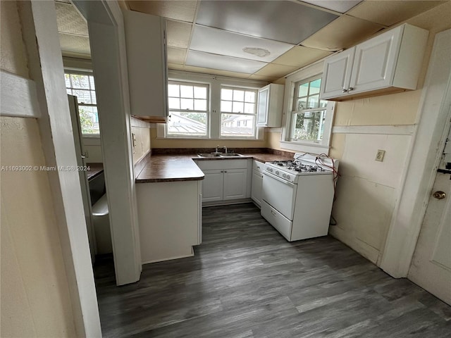 kitchen featuring white cabinetry, a paneled ceiling, dark wood-type flooring, and white gas stove