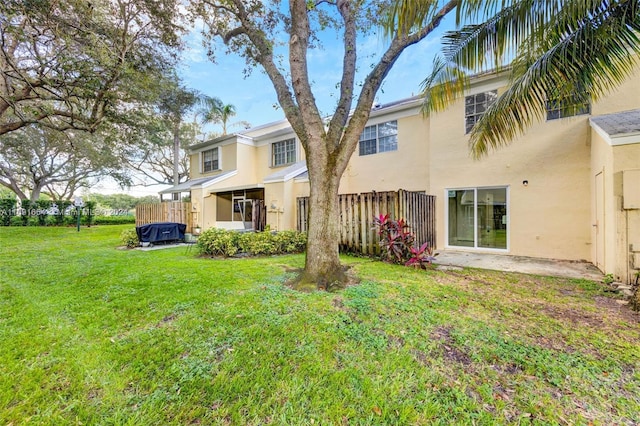 rear view of property with a lawn