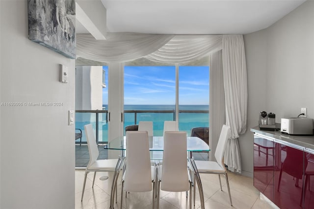 tiled dining room with a water view