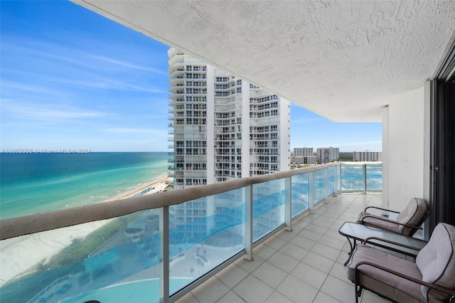 balcony with a view of the beach and a water view