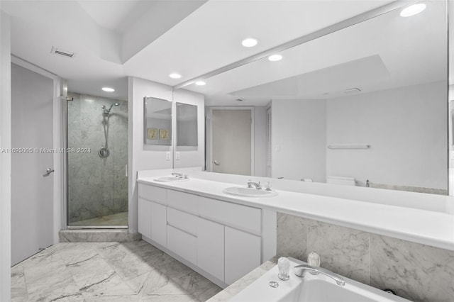 bathroom with vanity and separate shower and tub