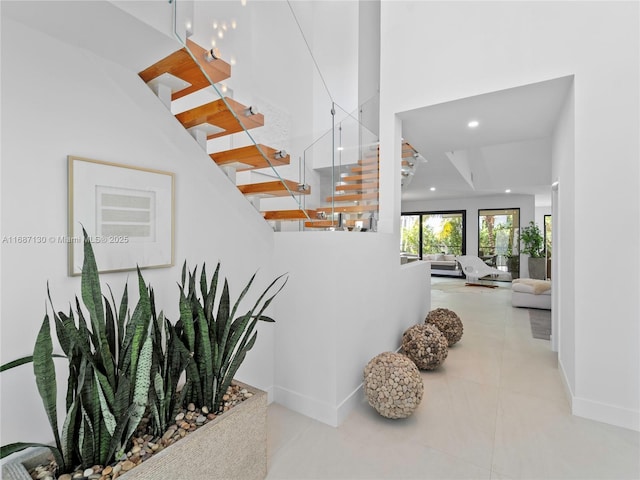 2000 S Bayshore Dr Unit 4, Coconut Grove, FL 33133 - corridor with stairs, a towering ceiling, baseboards, recessed lighting, and tile patterned flooring