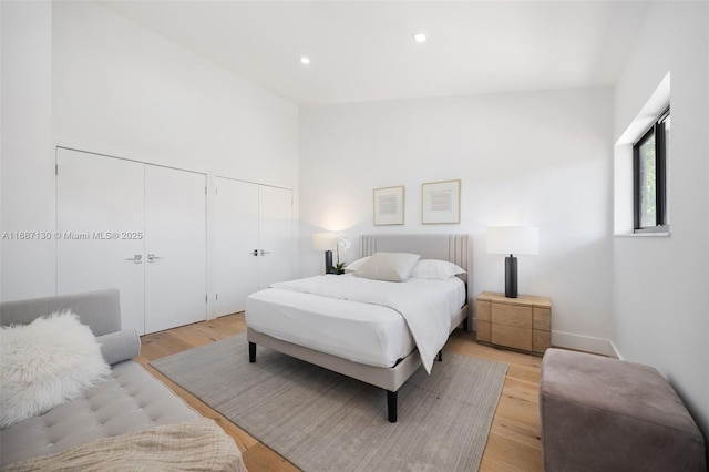 2000 S Bayshore Dr Unit 4, Coconut Grove, FL 33133 - bedroom featuring multiple closets, light wood-style flooring, and recessed lighting