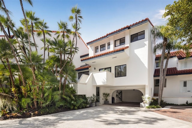 2000 S Bayshore Dr Unit 4, Coconut Grove, FL 33133 - mediterranean / spanish house with a garage, stucco siding, driveway, and a tiled roof