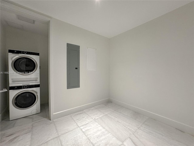 laundry area featuring stacked washing maching and dryer and electric panel