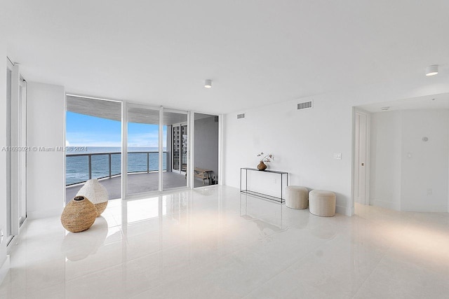 6301 Collins Ave Unit 1508, Miami Beach, FL 33141 - tiled empty room featuring a water view and a wall of windows