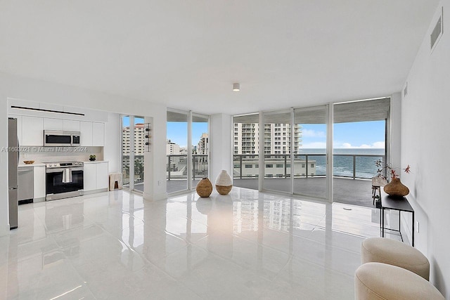 living room with expansive windows and a water view