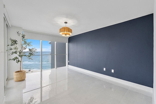 6301 Collins Ave Unit 1508, Miami Beach, FL 33141 - unfurnished room featuring a water view, baseboards, and light tile patterned flooring