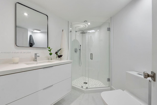 bathroom with walk in shower, vanity, and toilet