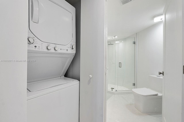 laundry area featuring stacked washer and clothes dryer