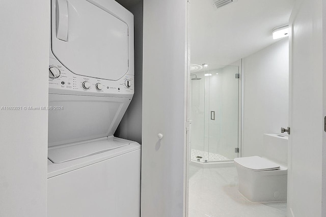 6301 Collins Ave Unit 1508, Miami Beach, FL 33141 - laundry room featuring estacked washer and dryer