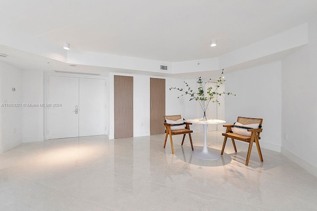 sitting room featuring a tray ceiling