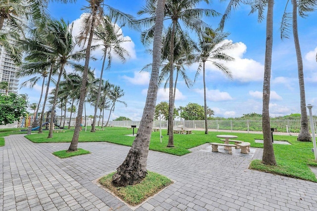 view of property's community with a lawn and a patio