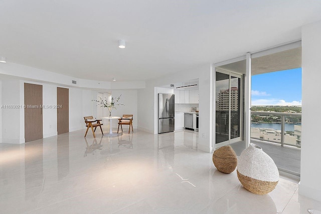 dining space featuring expansive windows and a water view