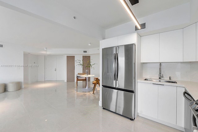 6301 Collins Ave Unit 1508, Miami Beach, FL 33141 - kitchen with freestanding refrigerator, a sink, light countertops, white cabinetry, and light tile patterned flooring