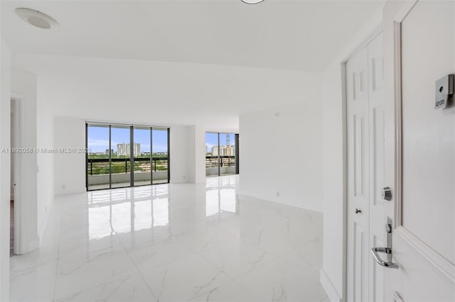 empty room with marble finish floor and floor to ceiling windows