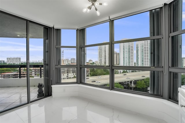 unfurnished sunroom with a city view