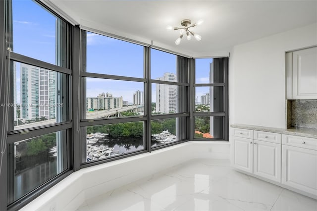 interior space with marble finish floor and a city view