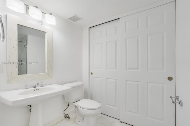 bathroom featuring tile patterned floors, toilet, and sink