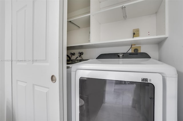 clothes washing area with laundry area and washing machine and clothes dryer