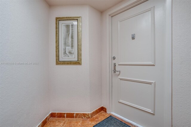 doorway to outside with tile patterned floors