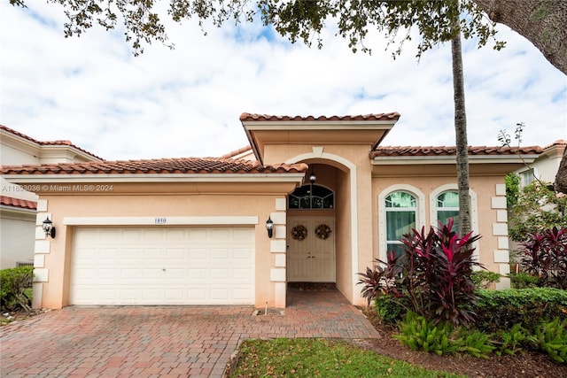 mediterranean / spanish-style house featuring a garage