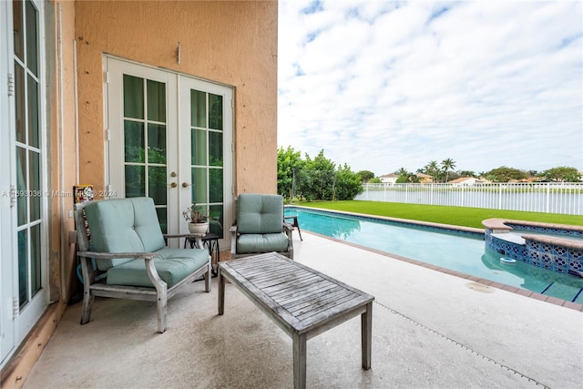 view of pool with an in ground hot tub, french doors, and a patio area