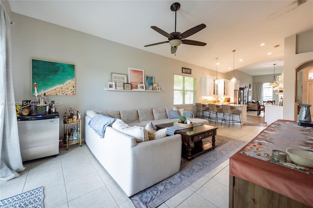 tiled living room featuring ceiling fan