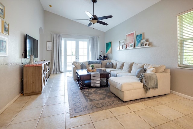 tiled living room with french doors, a healthy amount of sunlight, and ceiling fan