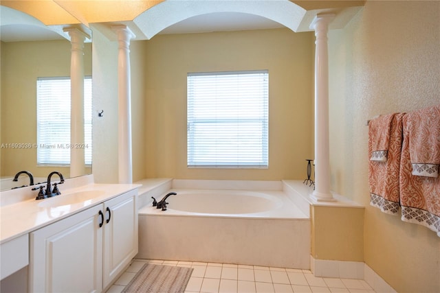 bathroom with vanity, a tub, tile patterned floors, and decorative columns