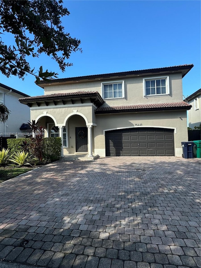 mediterranean / spanish-style house with a garage