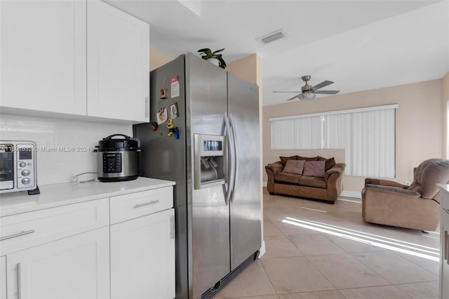 kitchen with white cabinetry, stainless steel refrigerator with ice dispenser, light tile patterned floors, and ceiling fan