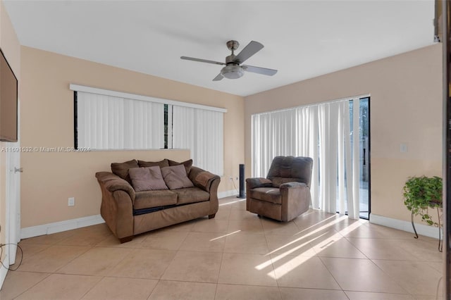 living room featuring light tile patterned floors and ceiling fan