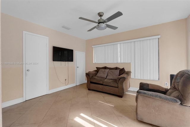 tiled living room with ceiling fan