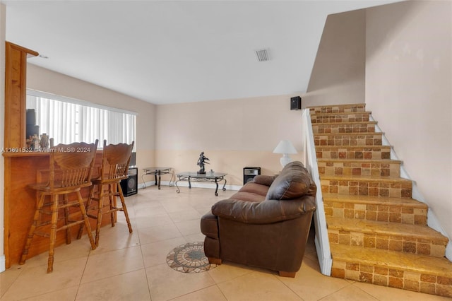 living room with bar and tile patterned floors