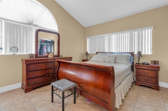 bedroom featuring light tile patterned flooring and vaulted ceiling