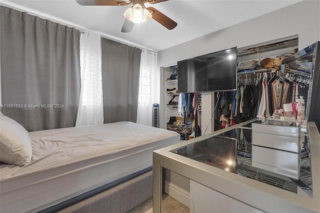 bedroom with ceiling fan and a closet