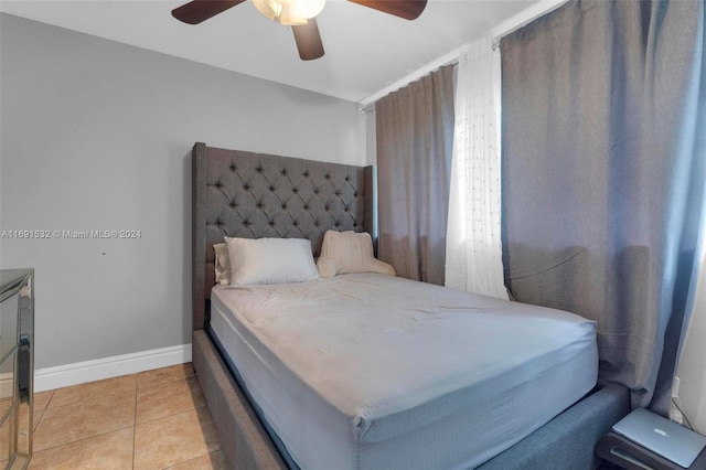 tiled bedroom with ceiling fan