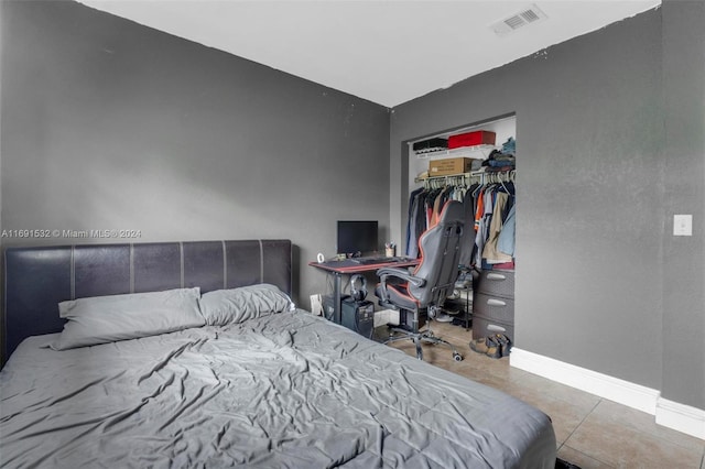 bedroom featuring tile patterned flooring and a closet