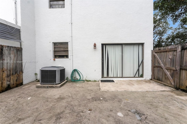 rear view of house featuring central AC unit