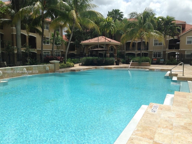 view of swimming pool featuring a gazebo and pool water feature