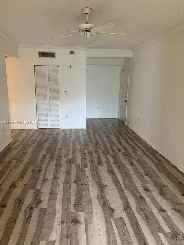 unfurnished room featuring hardwood / wood-style flooring, ceiling fan, and ornamental molding