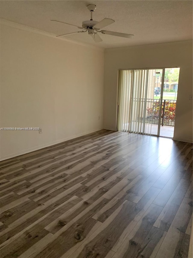 empty room with dark hardwood / wood-style floors and ceiling fan