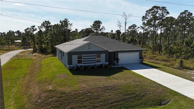 view of front of house with a front lawn and a garage